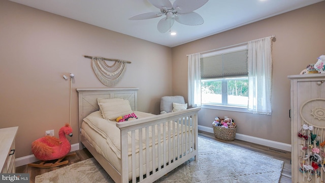 bedroom featuring ceiling fan and light hardwood / wood-style flooring