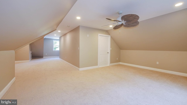 bonus room featuring lofted ceiling, light colored carpet, and ceiling fan