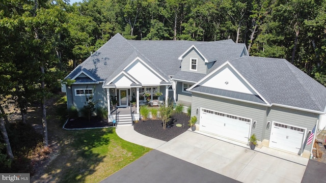 view of front facade featuring a porch and a garage