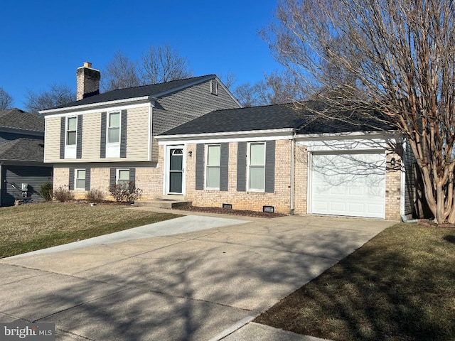 tri-level home with a garage and a front yard