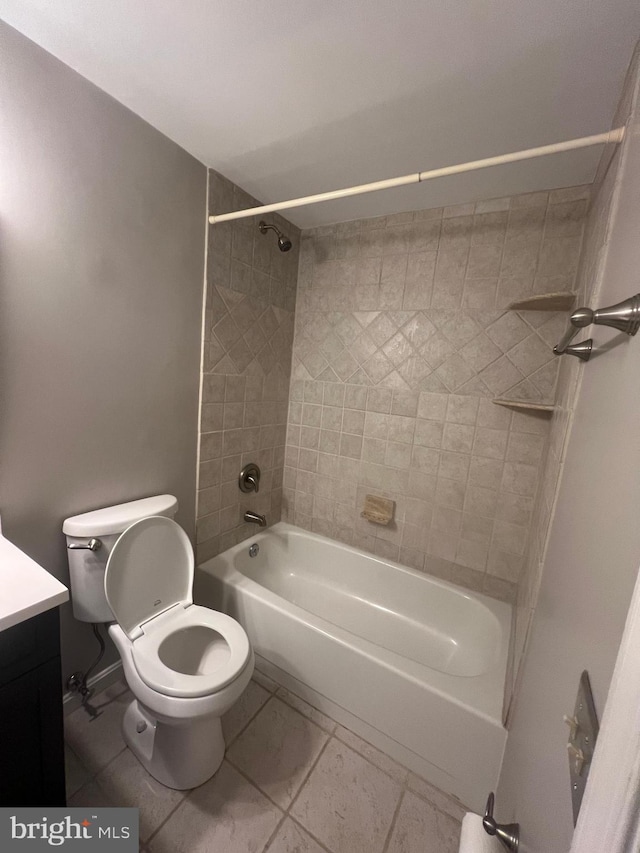 full bathroom with tiled shower / bath, vanity, and toilet