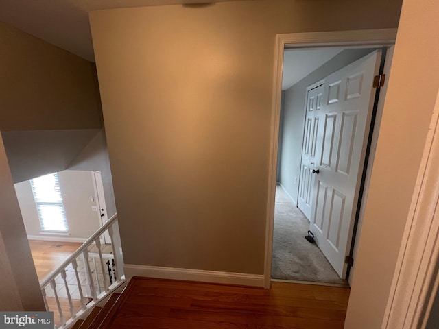 corridor with hardwood / wood-style floors