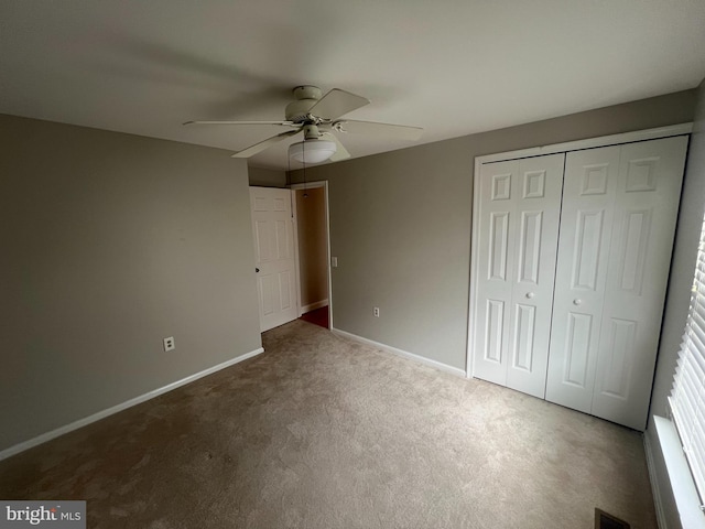 unfurnished bedroom with carpet flooring, ceiling fan, and a closet