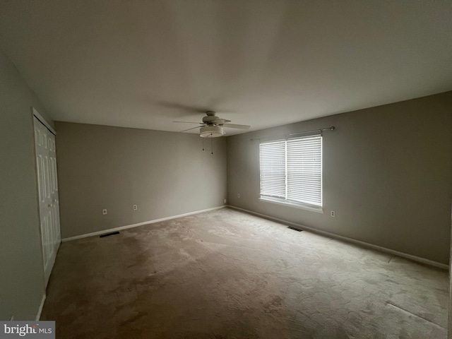 unfurnished bedroom featuring a closet, ceiling fan, and carpet