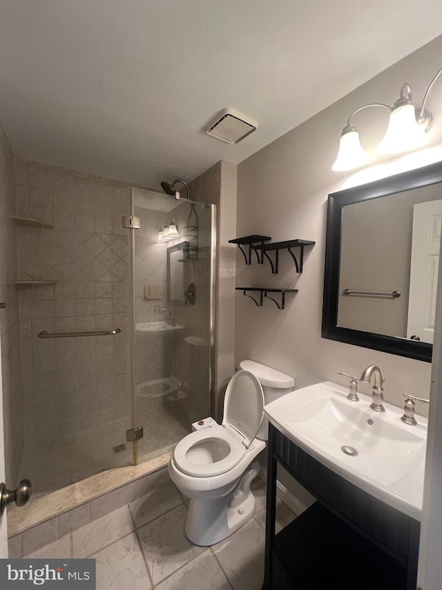 bathroom featuring vanity, toilet, and walk in shower