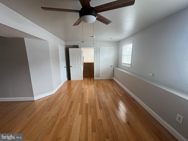 unfurnished bedroom featuring ceiling fan and light wood-type flooring