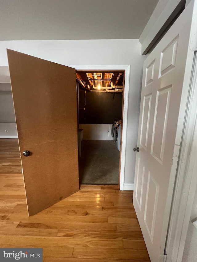 hallway with light hardwood / wood-style flooring