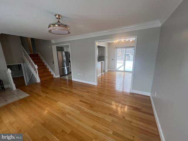 interior space featuring crown molding and light hardwood / wood-style flooring