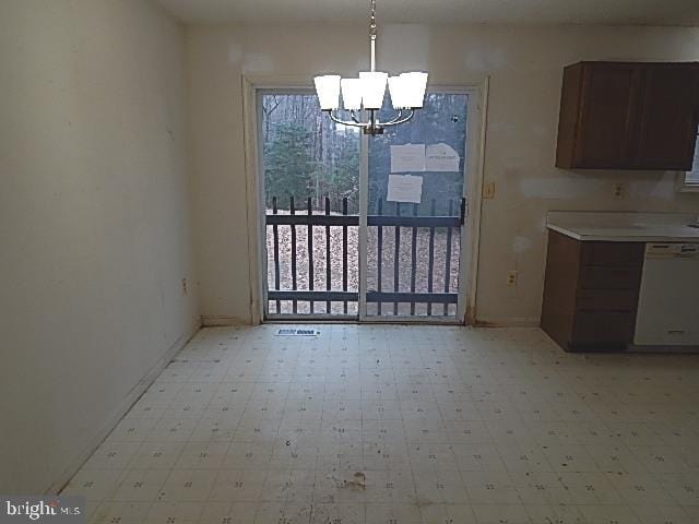 unfurnished dining area with a notable chandelier