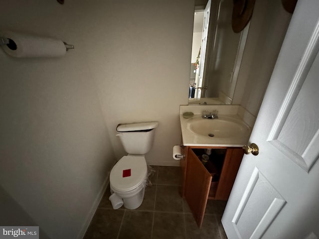 bathroom with vanity, tile patterned floors, and toilet