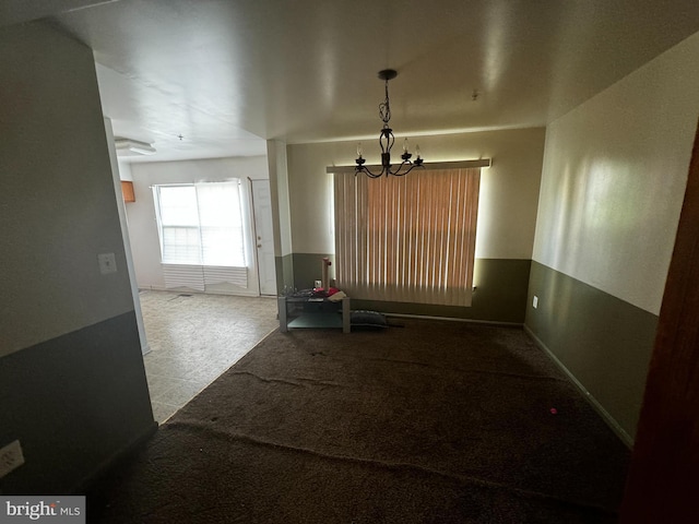 dining space featuring light colored carpet and a notable chandelier