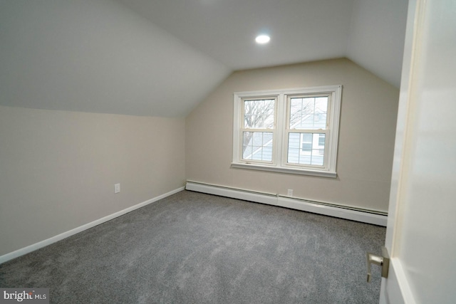 additional living space with a baseboard radiator, carpet floors, and vaulted ceiling