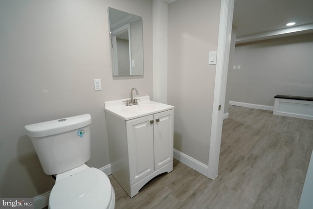 bathroom with vanity, hardwood / wood-style floors, and toilet