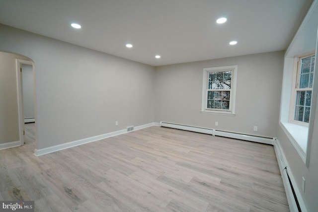 spare room featuring light hardwood / wood-style floors and baseboard heating