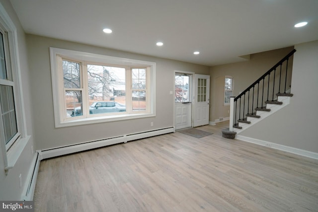 entrance foyer featuring light wood-type flooring and baseboard heating