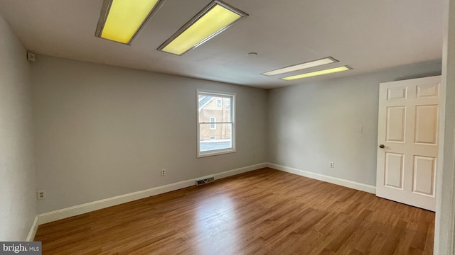 spare room with hardwood / wood-style floors