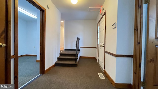 hallway with dark carpet