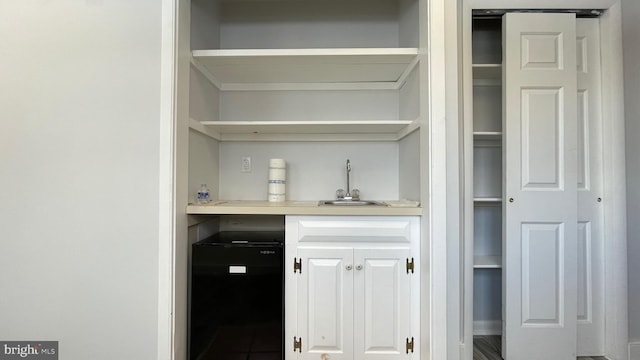 bar with sink and refrigerator