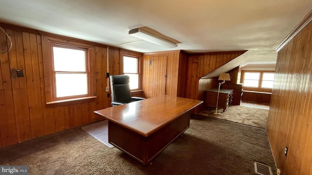 unfurnished office with dark colored carpet and wood walls