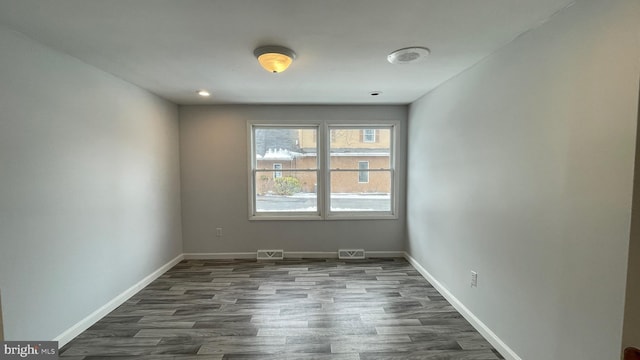 spare room featuring dark wood-type flooring