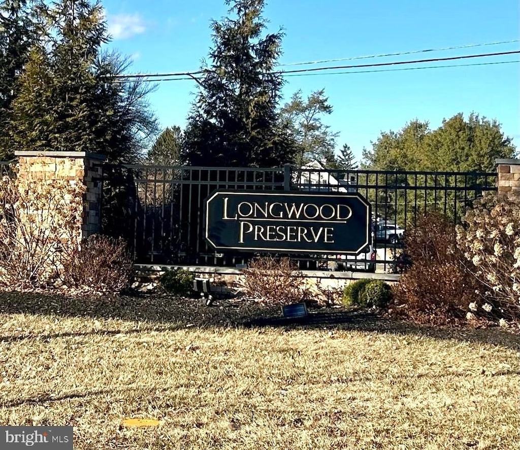 community / neighborhood sign with a lawn