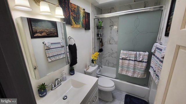 full bathroom featuring toilet, vanity, and bath / shower combo with glass door