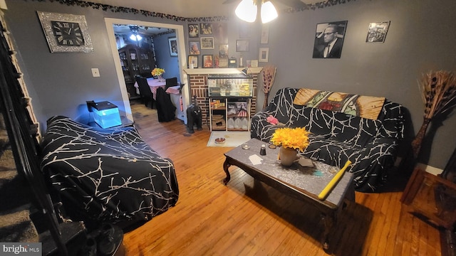 living room featuring ceiling fan and wood-type flooring