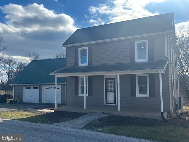 front of property featuring a garage, central AC, and a porch