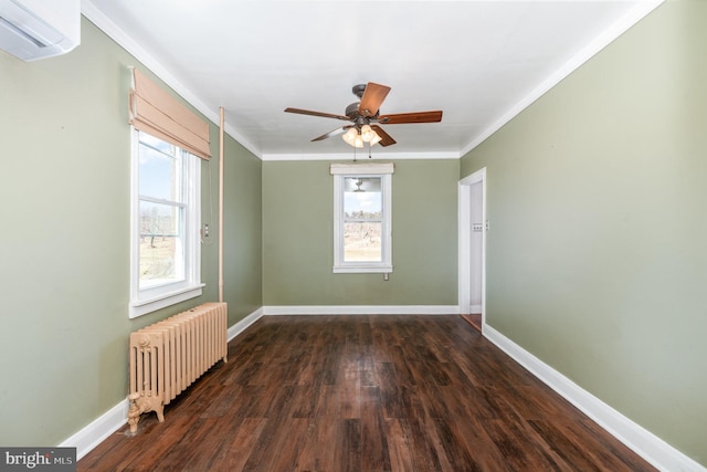 empty room featuring crown molding, an AC wall unit, dark hardwood / wood-style floors, radiator, and ceiling fan