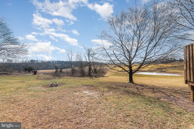 view of yard with a water view and a rural view