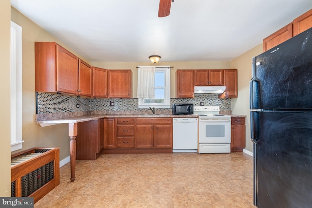 kitchen with sink, decorative backsplash, and black appliances