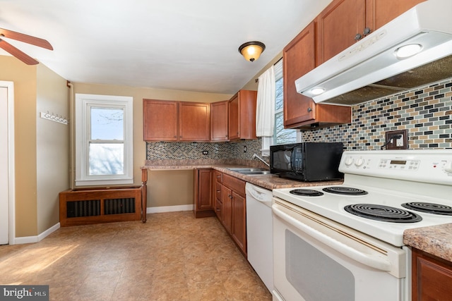 kitchen with sink, white appliances, a wealth of natural light, and decorative backsplash