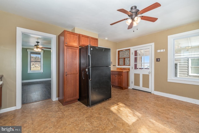 kitchen featuring black refrigerator and ceiling fan