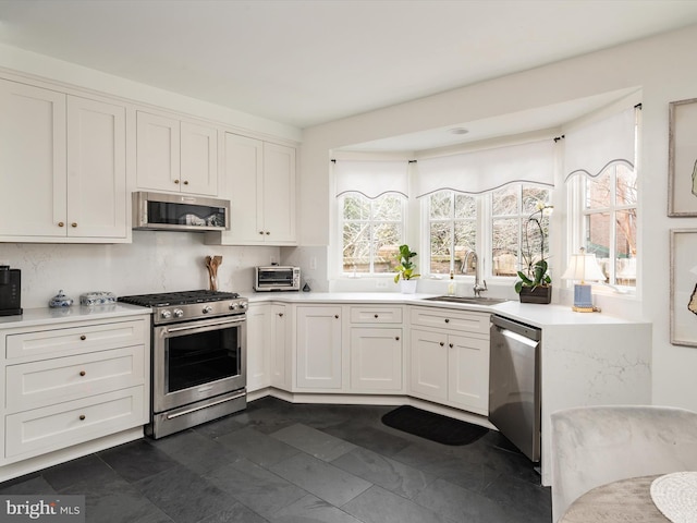 143 Market St, Annapolis, MD 21401 - kitchen with sink, backsplash, stainless steel appliances, and white cabinets