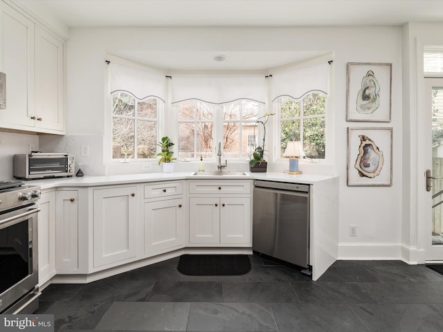 143 Market St, Annapolis, MD 21401 - kitchen featuring white cabinetry, appliances with stainless steel finishes, and sink