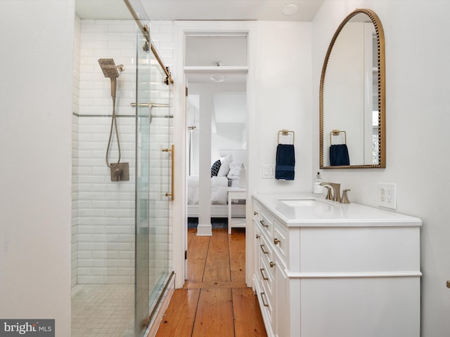 143 Market St, Annapolis, MD 21401 - bathroom featuring wood-type flooring, a shower with door, and vanity
