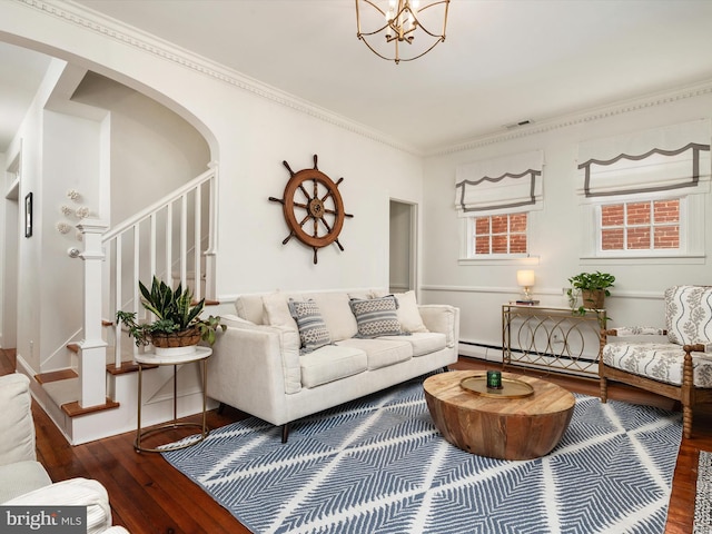 143 Market St, Annapolis, MD 21401 - living room featuring an inviting chandelier, crown molding, dark wood-type flooring, and baseboard heating