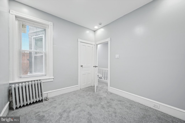 carpeted spare room with radiator