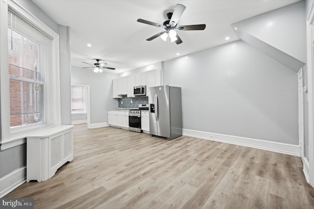 kitchen featuring white cabinetry, appliances with stainless steel finishes, ceiling fan, light hardwood / wood-style floors, and decorative backsplash