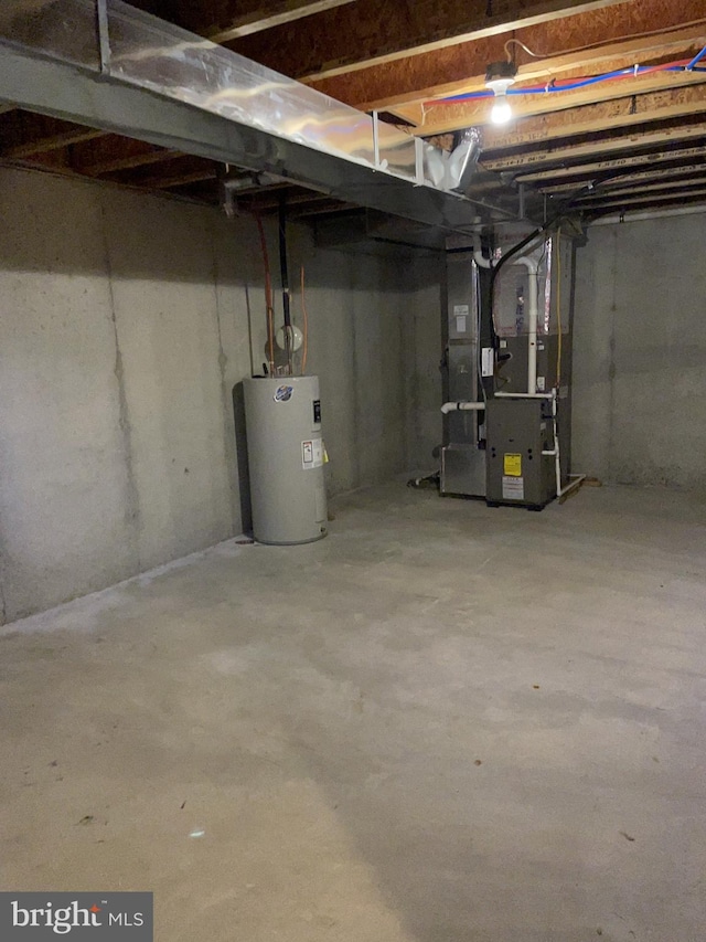 basement featuring electric water heater and heating unit