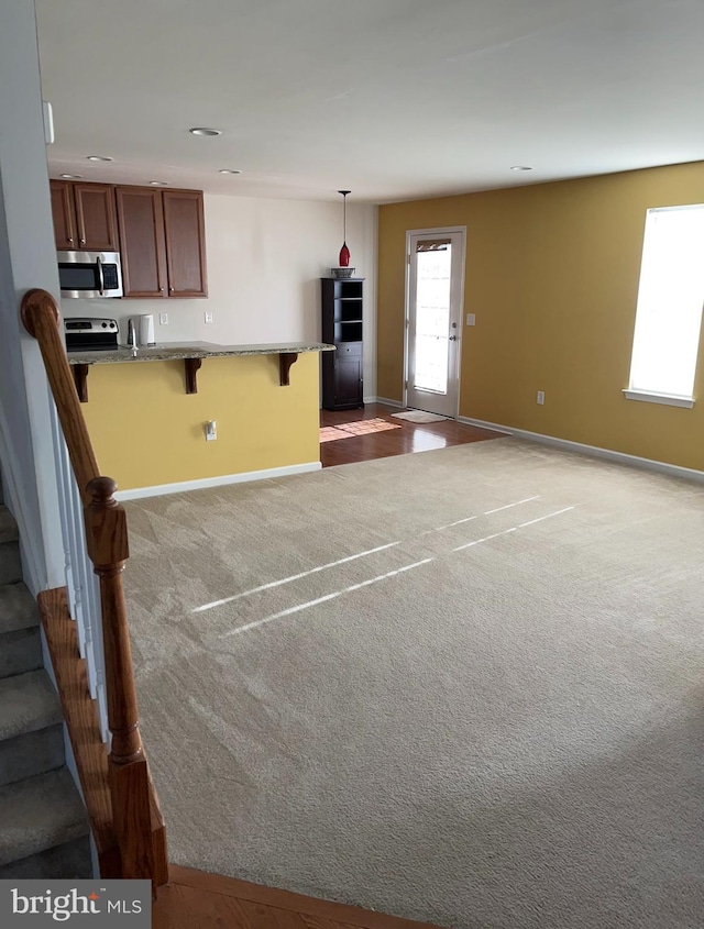 unfurnished living room with light carpet