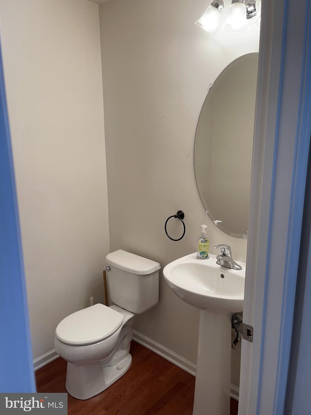 bathroom with wood-type flooring and toilet