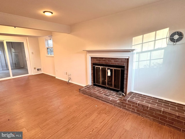 unfurnished living room featuring a fireplace and hardwood / wood-style flooring