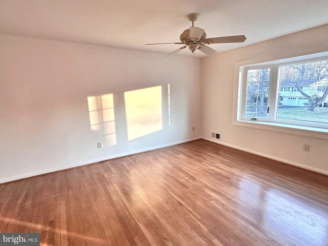 unfurnished room featuring ceiling fan and hardwood / wood-style floors