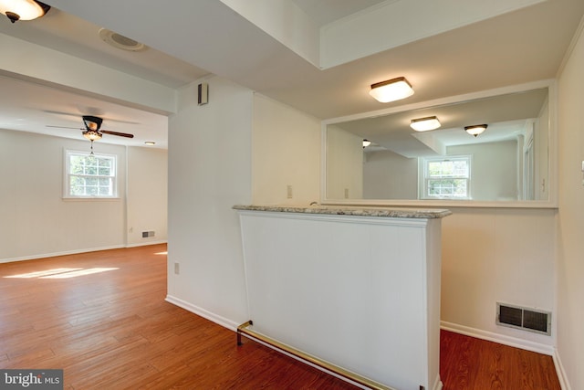 kitchen with ceiling fan, wood-type flooring, and kitchen peninsula