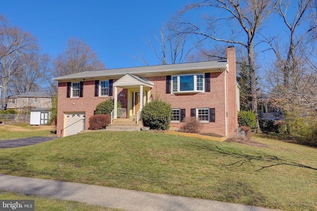 bi-level home featuring a garage and a front yard