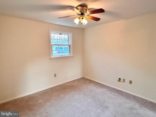 carpeted spare room featuring ceiling fan