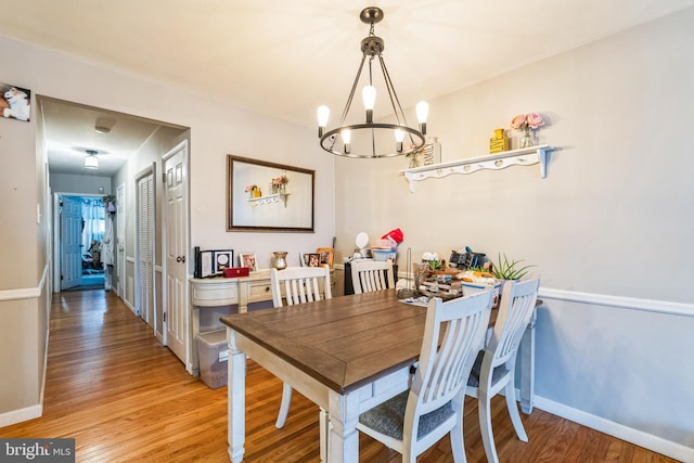 dining space featuring a chandelier and hardwood / wood-style floors