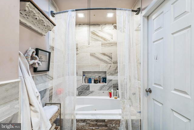 bathroom featuring shower / tub combo with curtain and tile walls