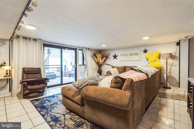 bedroom featuring light tile patterned flooring, rail lighting, and access to outside